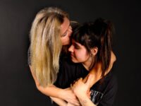 woman kissing girl on forehead