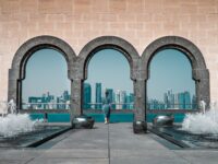 brown building with stonewall and arches