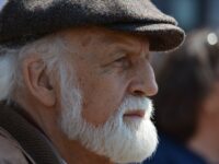 selective focus photography of man in flat cap during daytime